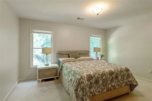 a bed sitting in a bedroom next to a window