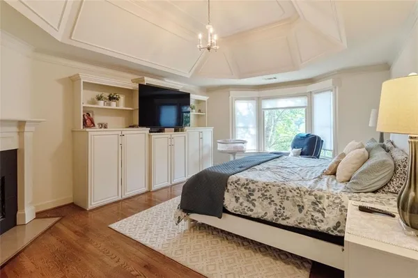 a bedroom with a bed and flat screen tv
