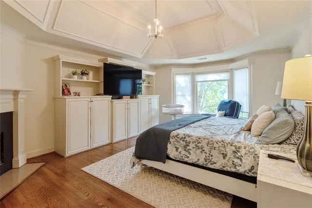 a bedroom with a bed and flat screen tv