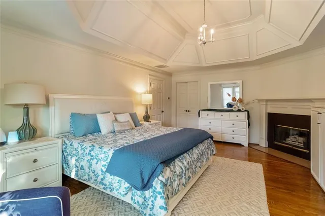 a bedroom with a bed and a fireplace