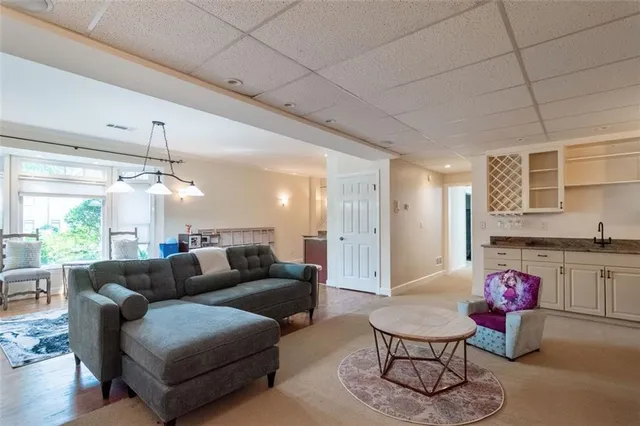 a living room with furniture and a chandelier