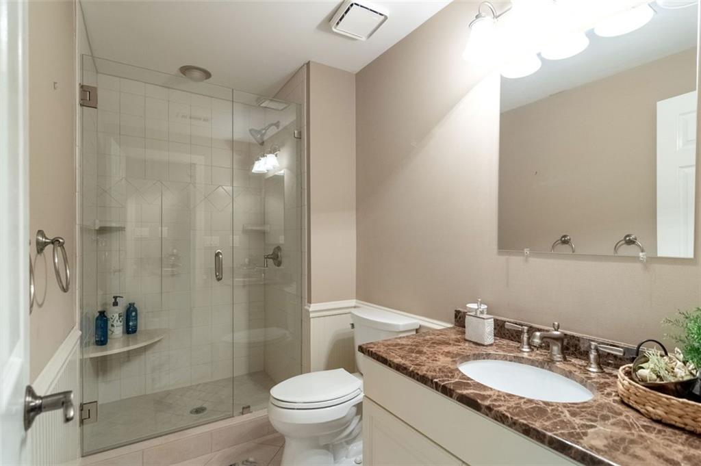 3850 Glenhurst Drive Smyrna, GA 30080 - Photo 37 of 43 a bathroom with a granite countertop sink a toilet and shower