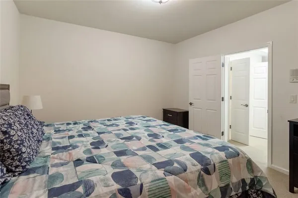 a bedroom with a bed and a dresser