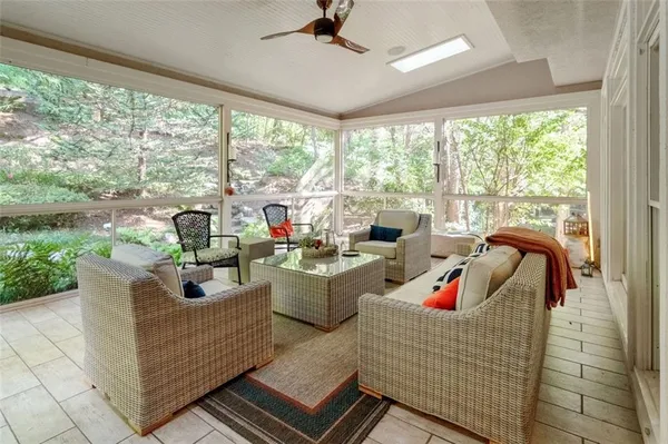a living room with furniture and a floor to ceiling window