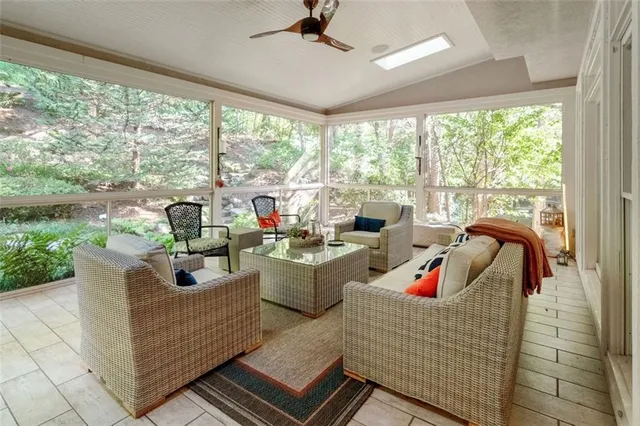 a living room with furniture and a floor to ceiling window