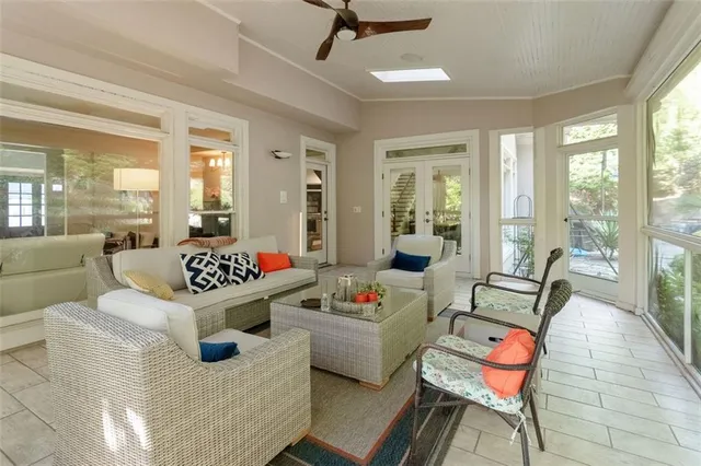 a living room with furniture and a floor to ceiling window