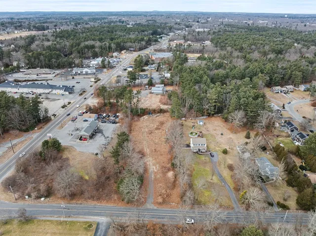 an aerial view of a houses with a yard