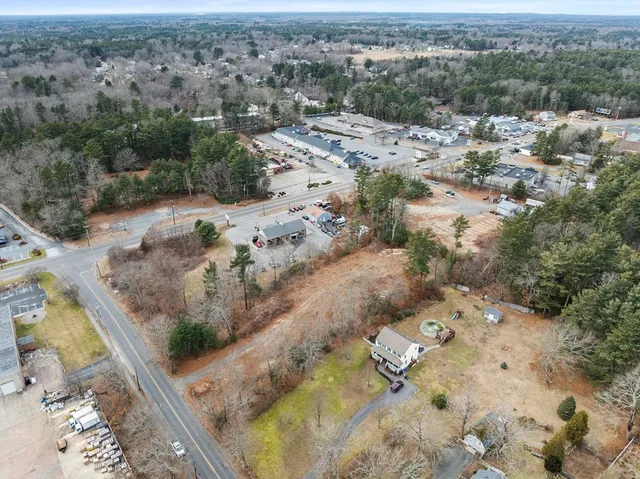an aerial view of a house with a yard