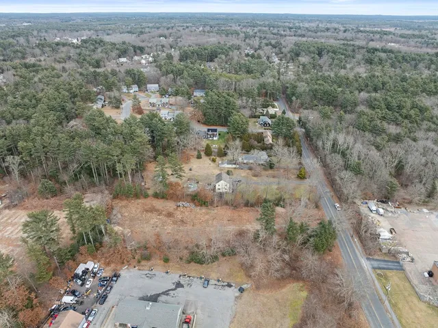 an aerial view of a houses with beach
