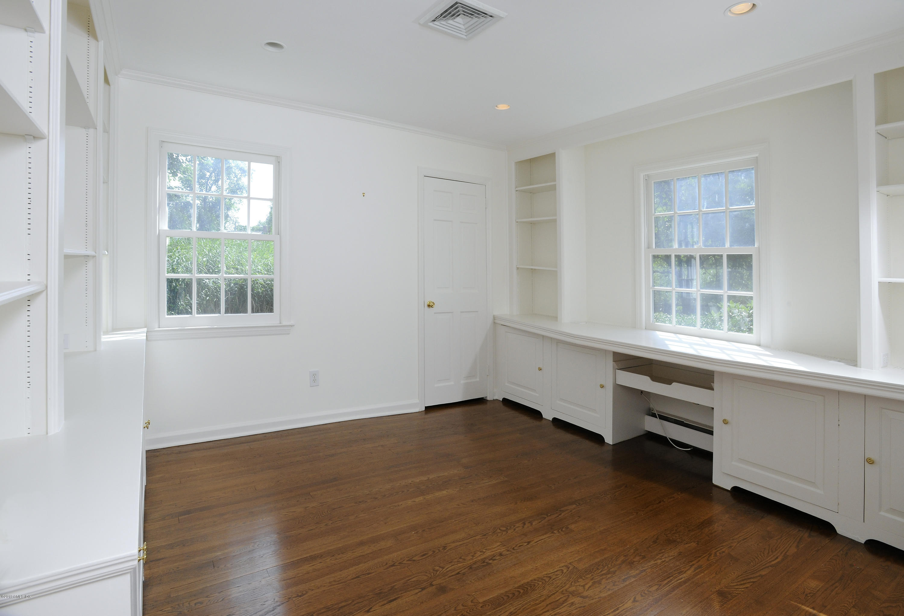 177 Indian Head Road Riverside, CT 06878 - Photo 13 of 24 an empty room with wooden floor and windows