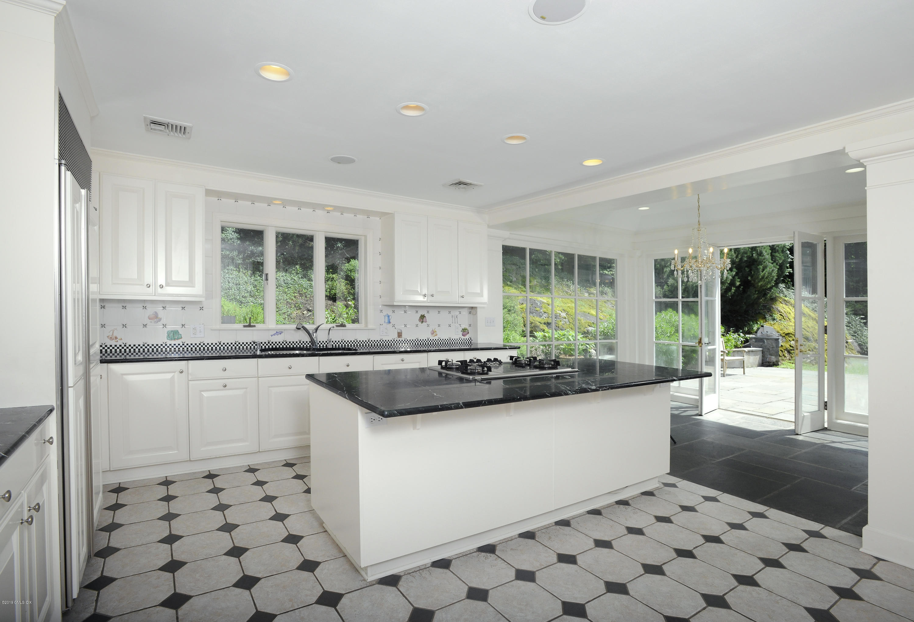 177 Indian Head Road Riverside, CT 06878 - Photo 14 of 24 a kitchen with stainless steel appliances a sink a stove a refrigerator and cabinets