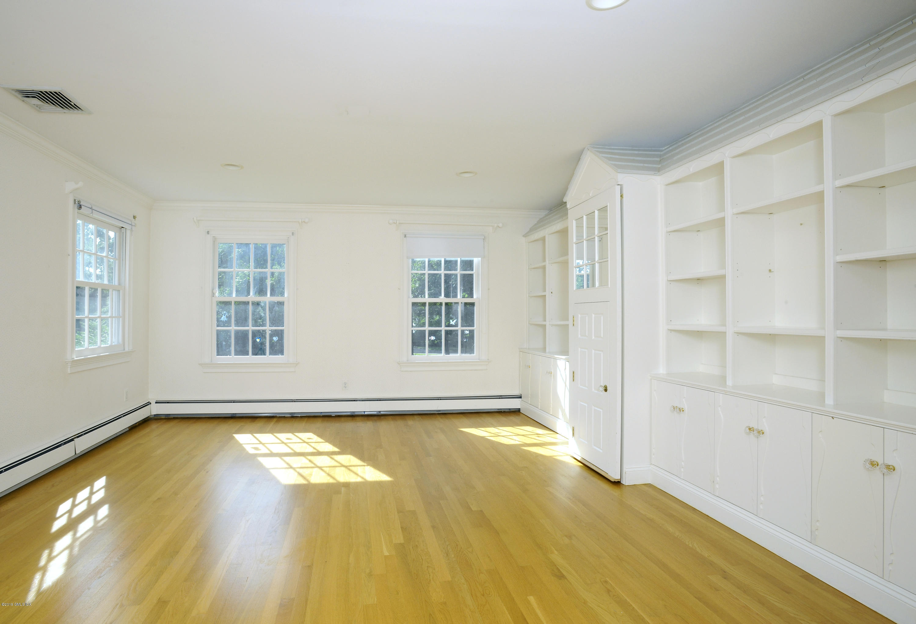 177 Indian Head Road Riverside, CT 06878 - Photo 19 of 24 a view of an empty room with window and wooden floor