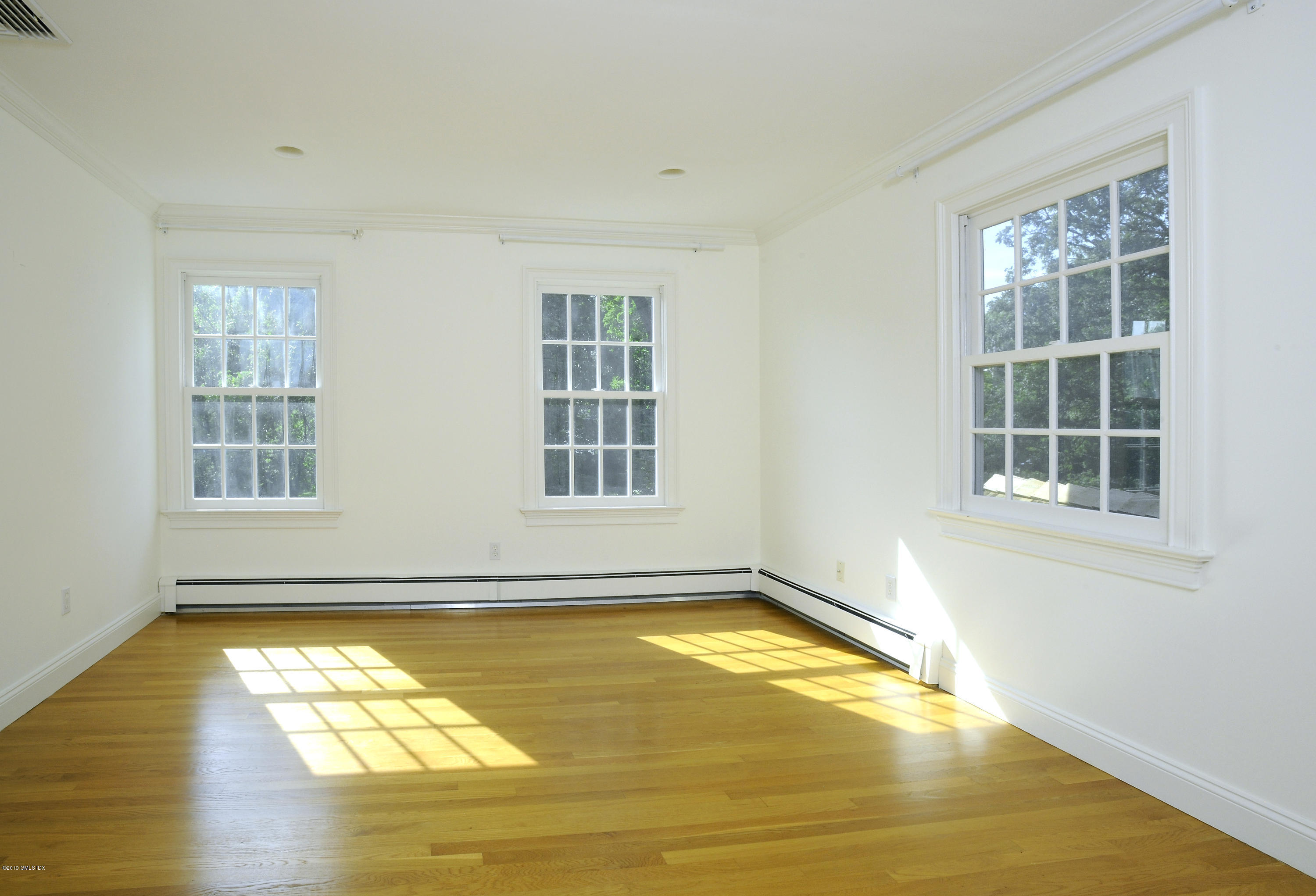 177 Indian Head Road Riverside, CT 06878 - Photo 22 of 24 a view of a room with wooden floor and windows