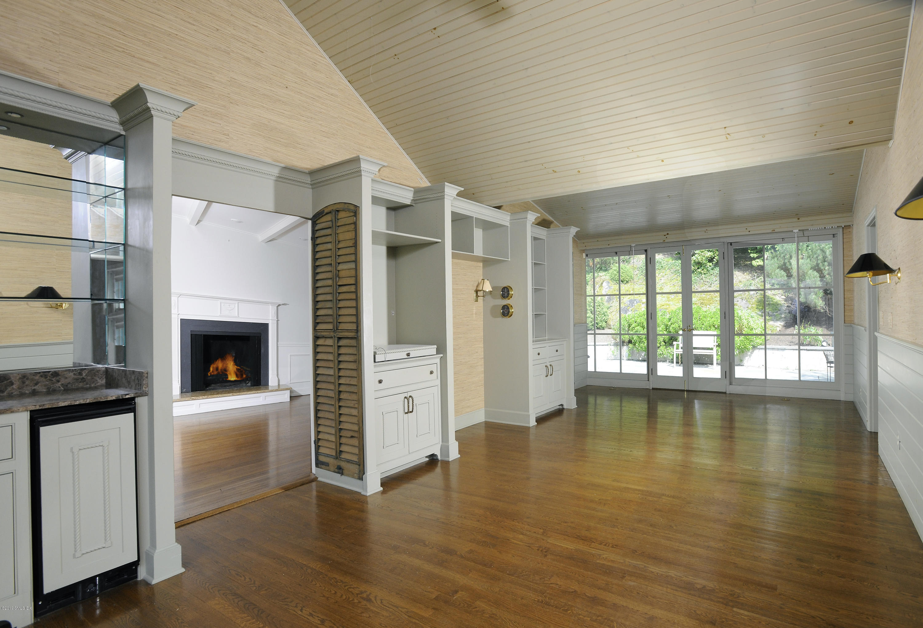 177 Indian Head Road Riverside, CT 06878 - Photo 9 of 24 a view of a livingroom with wooden floor and a fireplace