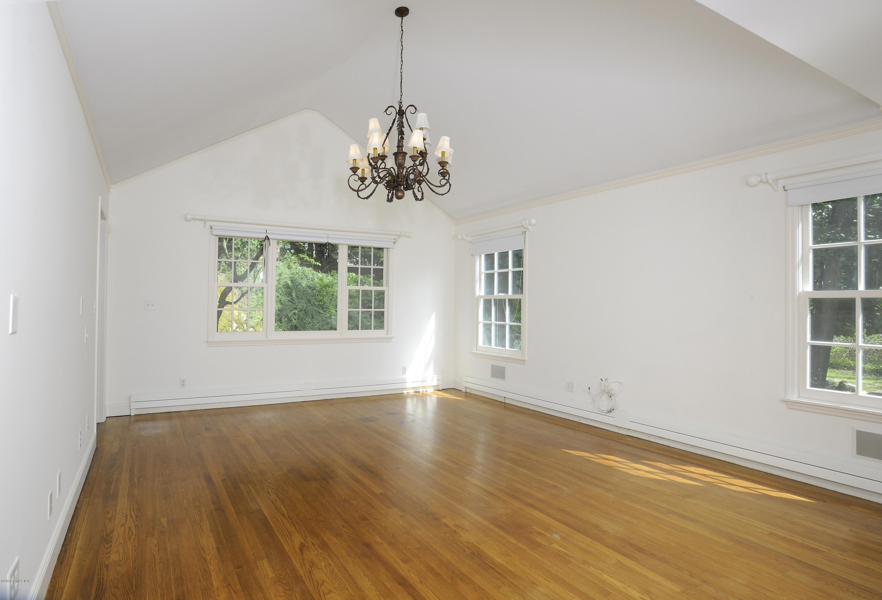 177 Indian Head Road Riverside, CT 06878 - Photo 10 of 24 a view of an empty room with wooden floor and a window