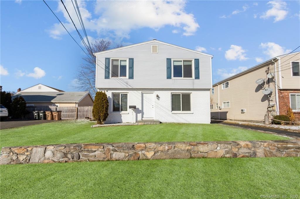 31 Mariners Lane Stamford, CT 06902 - Photo 1 of 1 a front view of a house with a garden and yard