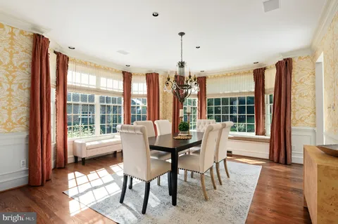 a dining room with furniture window and wooden floor
