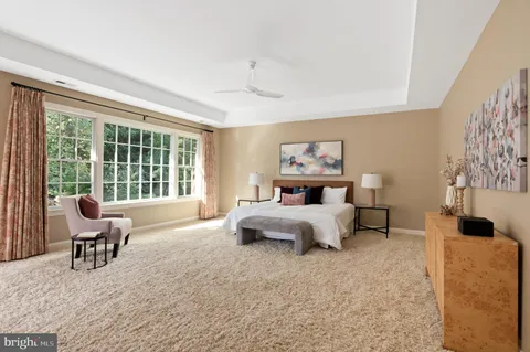 a bedroom with furniture and a large window