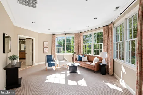a living room with furniture and large windows