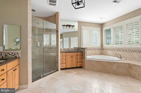 a spacious bathroom with a tub shower and sink