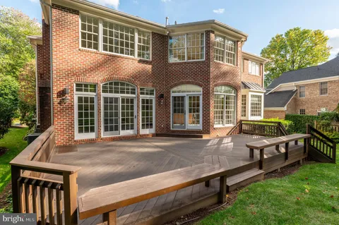 a view of a house with a wooden fence