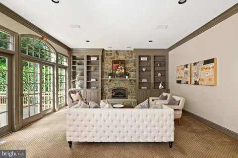a living room with furniture large window and flat screen tv