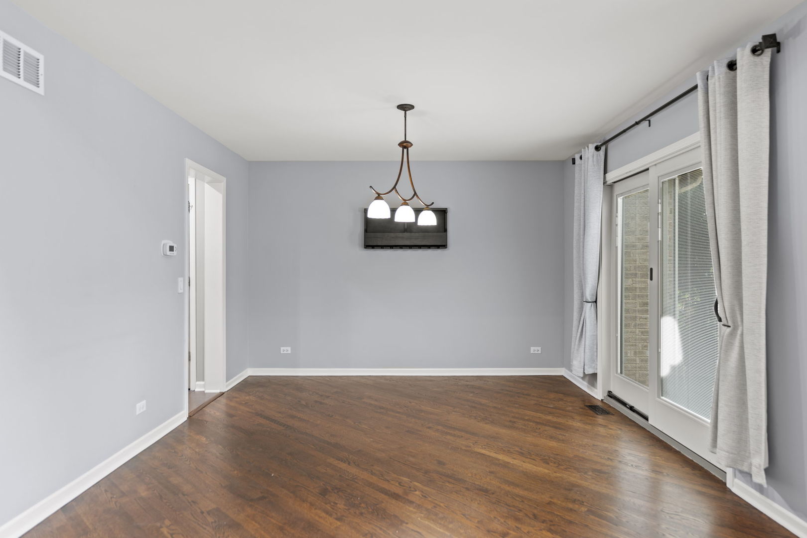 5509 Aspen Avenue Downers Grove, IL 60515 - Photo 13 of 38 an empty room with wooden floor mirror and windows