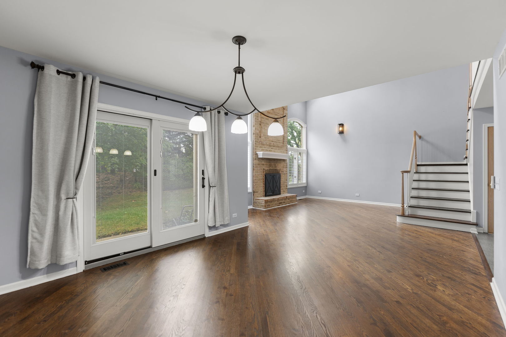 5509 Aspen Avenue Downers Grove, IL 60515 - Photo 14 of 38 a view of a room with wooden floor stairs and a chandelier