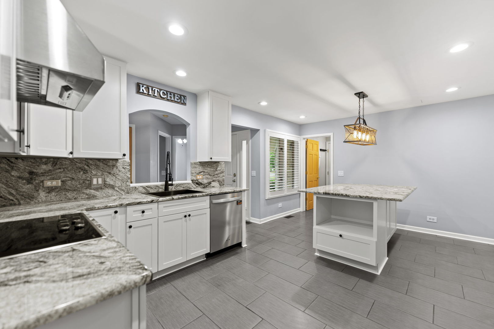 5509 Aspen Avenue Downers Grove, IL 60515 - Photo 7 of 38 a kitchen with granite countertop a sink and white cabinets