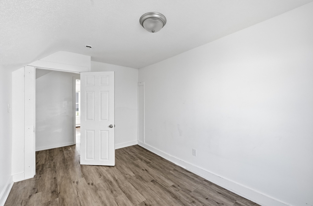 5 Floyd Street Lowell, MA 01852 - Photo 13 of 35 a view of empty room with wooden floor