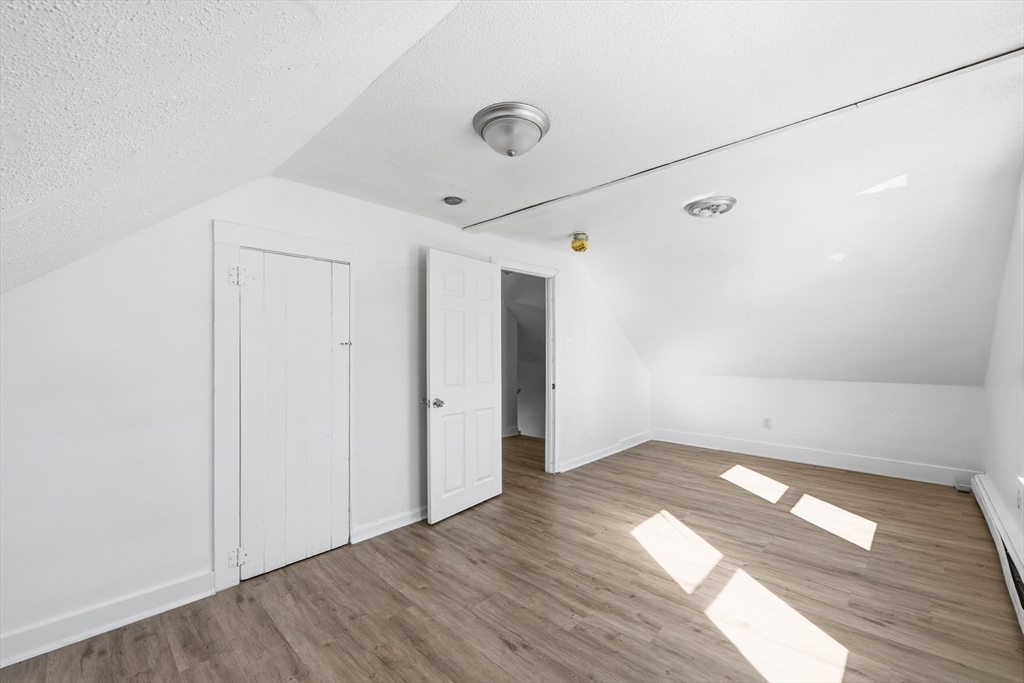5 Floyd Street Lowell, MA 01852 - Photo 15 of 35 an empty room with wooden floor and windows