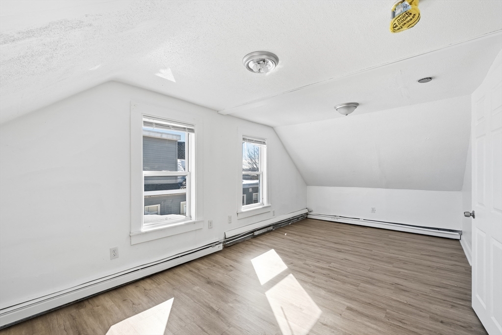5 Floyd Street Lowell, MA 01852 - Photo 17 of 35 an empty room with wooden floor and windows