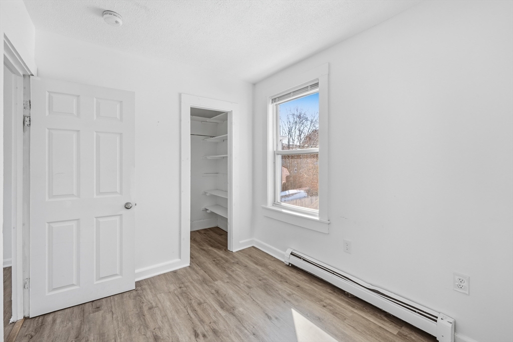 5 Floyd Street Lowell, MA 01852 - Photo 18 of 35 a view of an empty room with wooden floor and a window