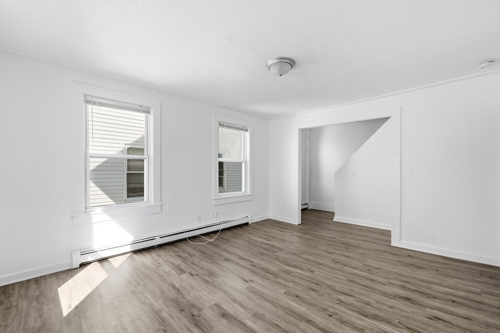 5 Floyd Street Lowell, MA 01852 - Photo 20 of 35 an empty room with wooden floor and windows