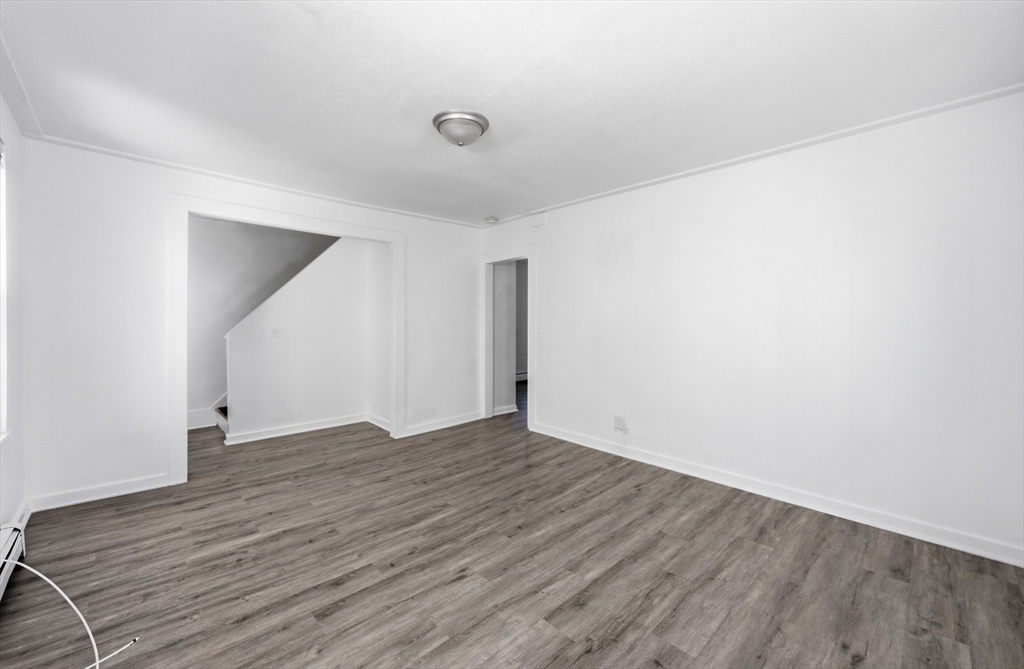 5 Floyd Street Lowell, MA 01852 - Photo 21 of 35 a view of an empty room with wooden floor and a window