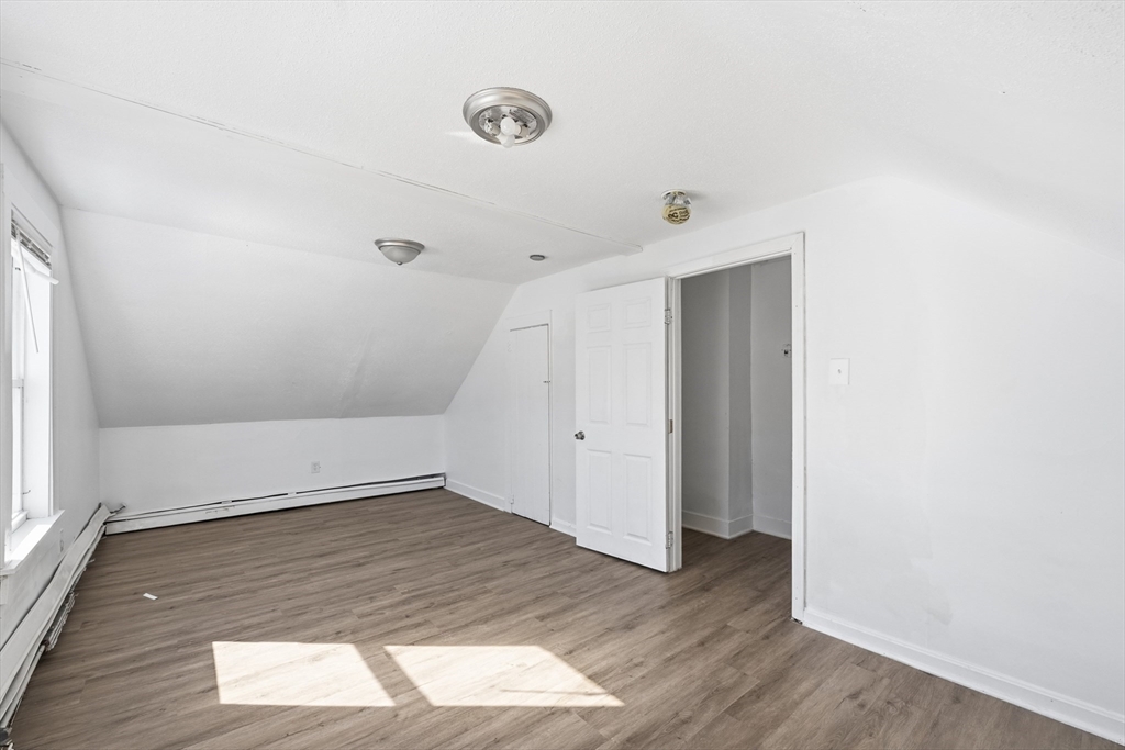 5 Floyd Street Lowell, MA 01852 - Photo 23 of 35 an empty room with wooden floor and windows