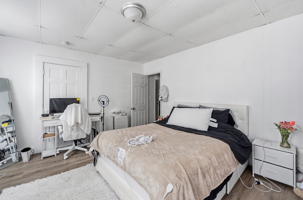 5 Floyd Street Lowell, MA 01852 - Photo 31 of 35 a bedroom with bed and chair