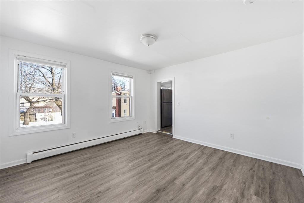 5 Floyd Street Lowell, MA 01852 - Photo 10 of 35 an empty room with wooden floor and windows
