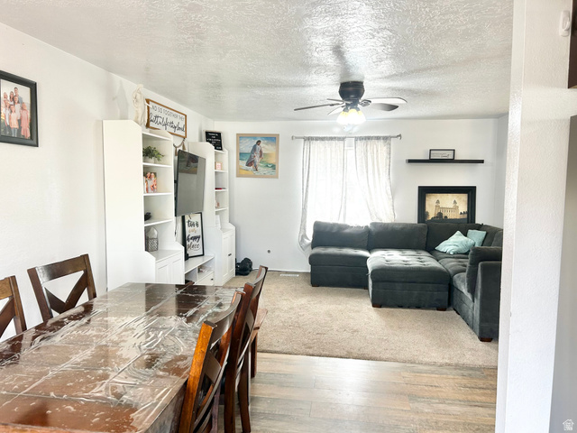 570 250 East Parowan, UT 84761 - Photo 3 of 27 Open-concept living space featuring wood-finish flooring extending into the dining area