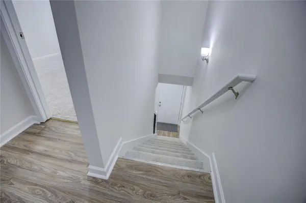 a view of entryway and hall with wooden floor
