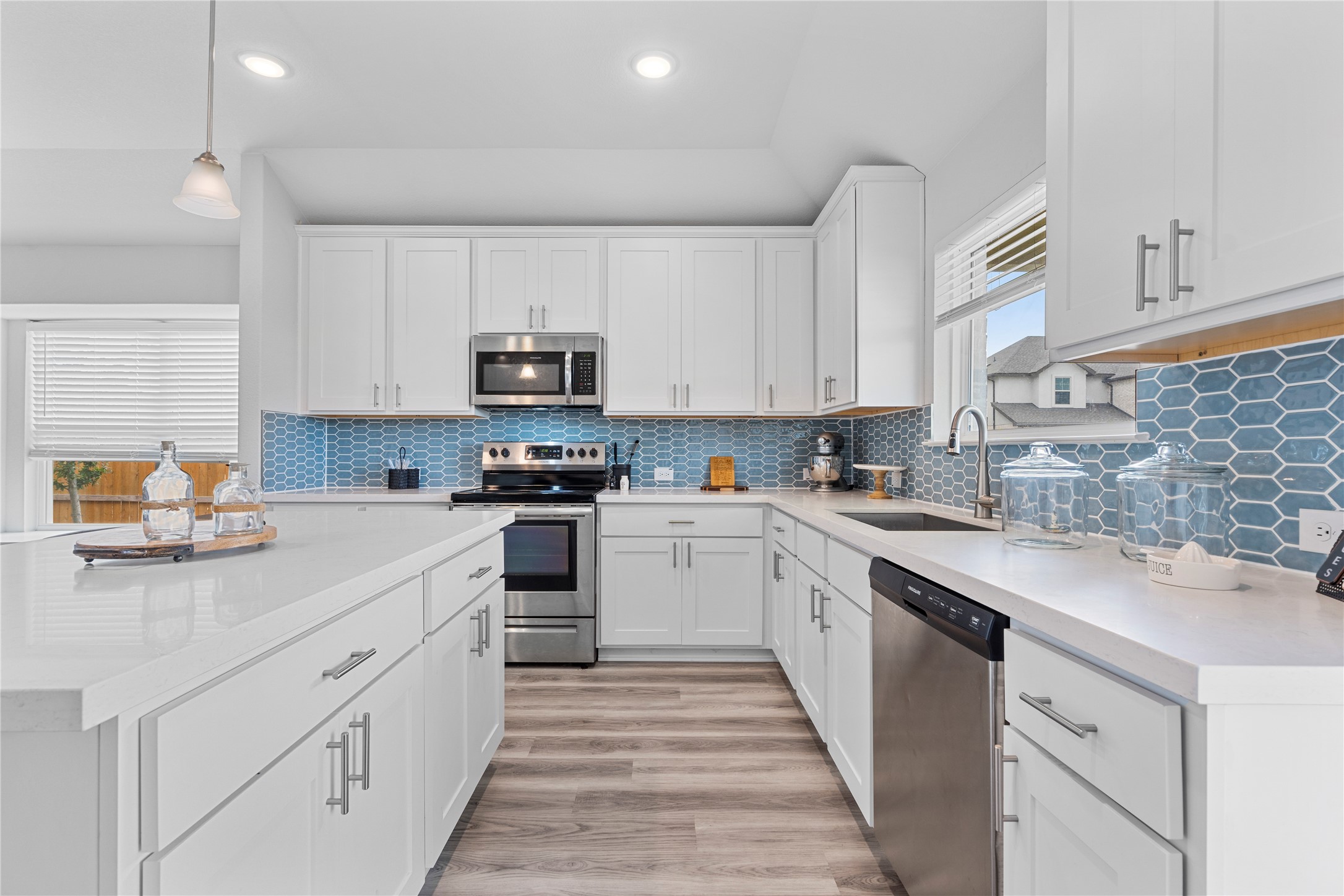 660 Pheasant Hill Lane Georgetown, TX 78628 - Photo 12 of 38 a kitchen with granite countertop white cabinets and white appliances