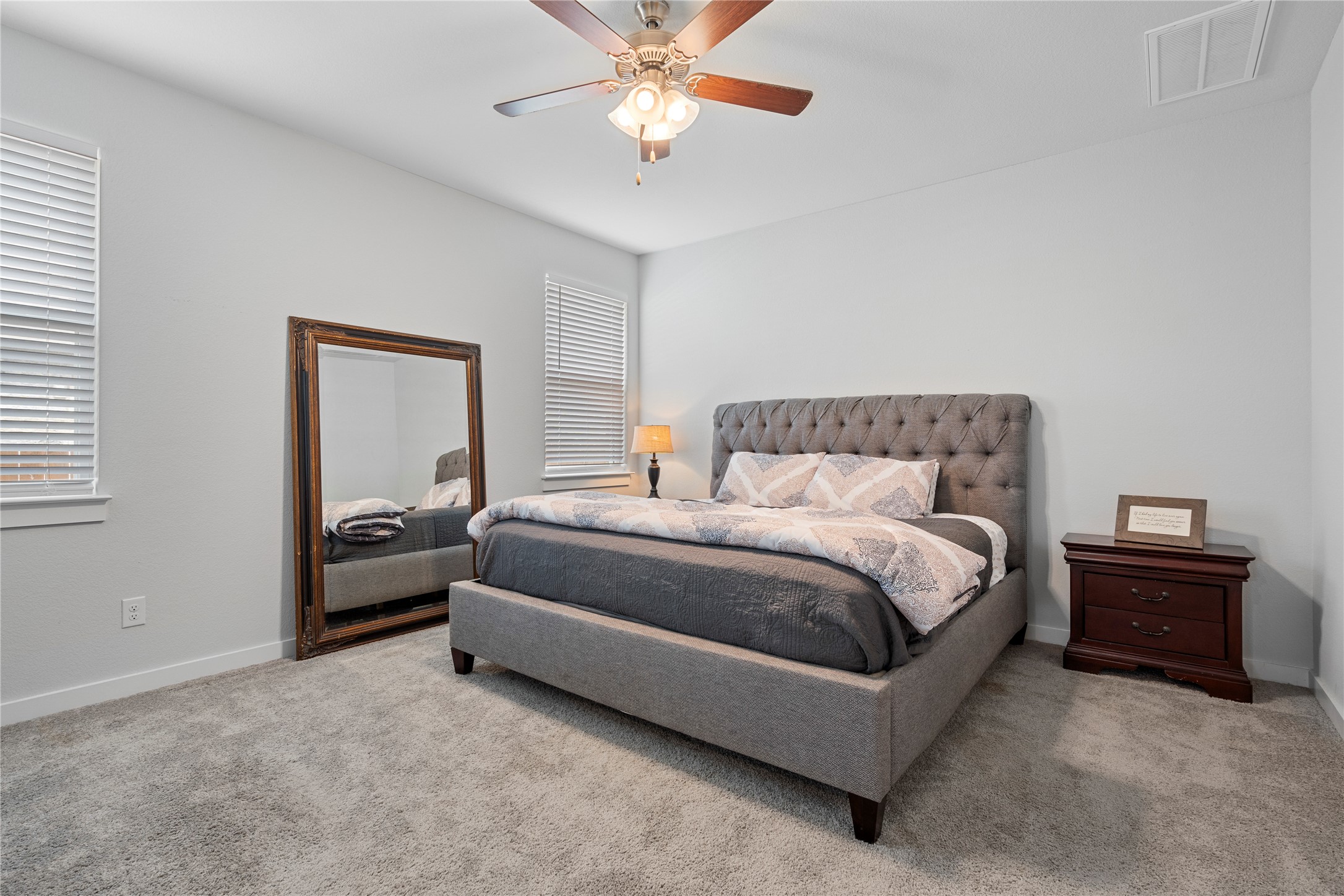 660 Pheasant Hill Lane Georgetown, TX 78628 - Photo 14 of 38 a bedroom with a bed and a chandelier