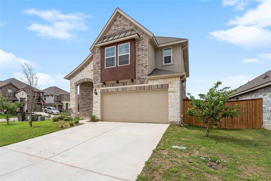 660 Pheasant Hill Lane Georgetown, TX 78628 - Photo 2 of 38 a front view of a house with a yard and garage