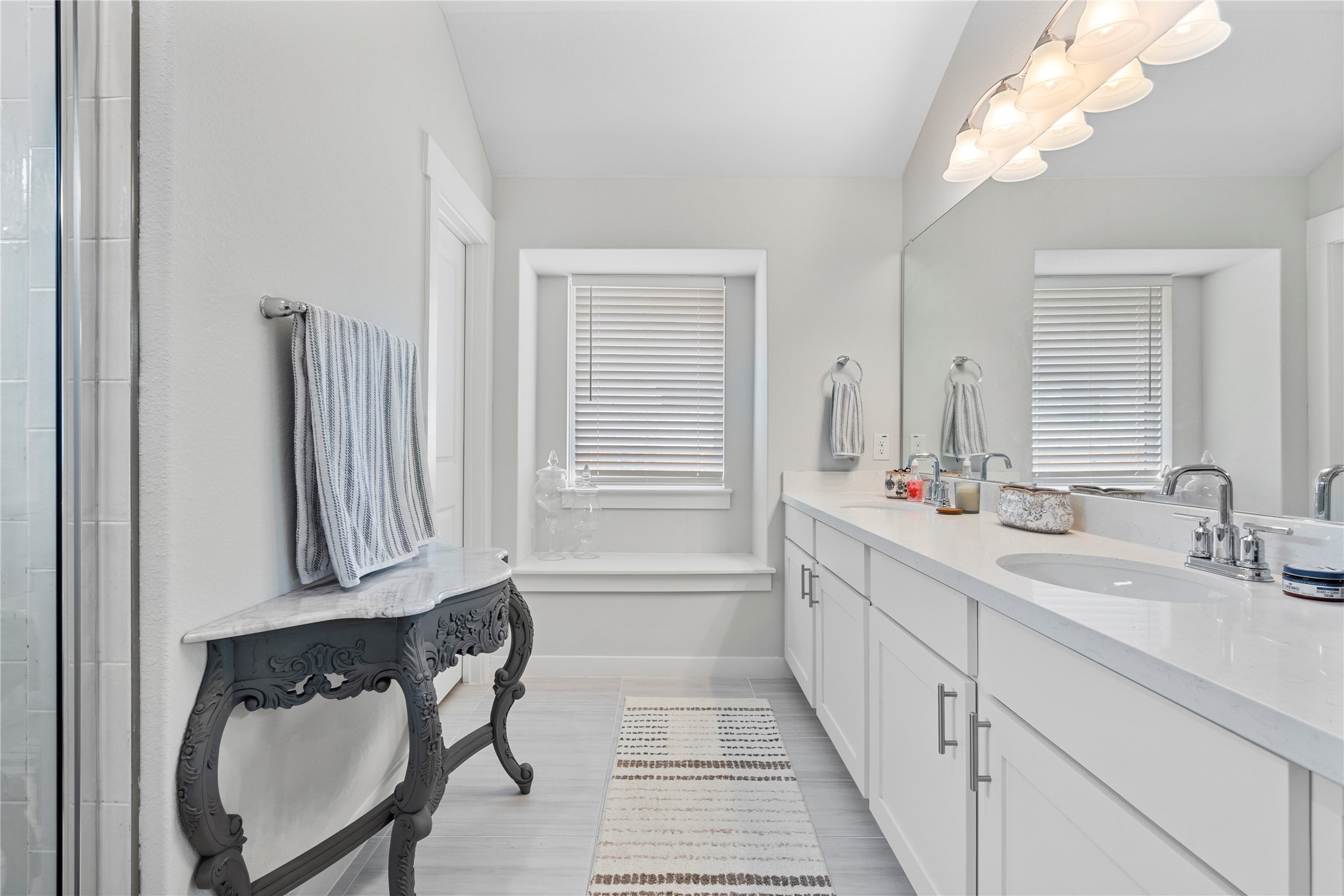 660 Pheasant Hill Lane Georgetown, TX 78628 - Photo 18 of 38 a bathroom with a double vanity sink and a mirror