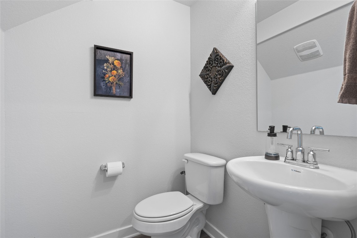 660 Pheasant Hill Lane Georgetown, TX 78628 - Photo 20 of 38 a white toilet sitting next to a white sink