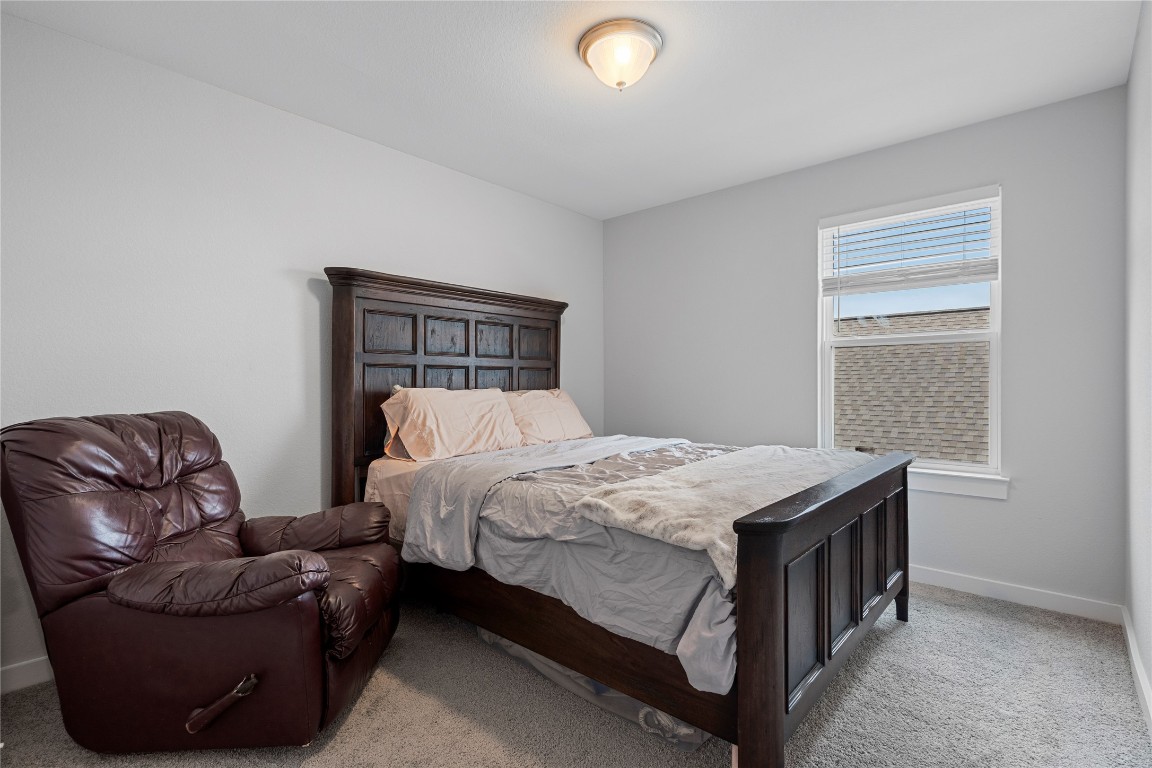 660 Pheasant Hill Lane Georgetown, TX 78628 - Photo 27 of 38 a bed room with a bed and a chair