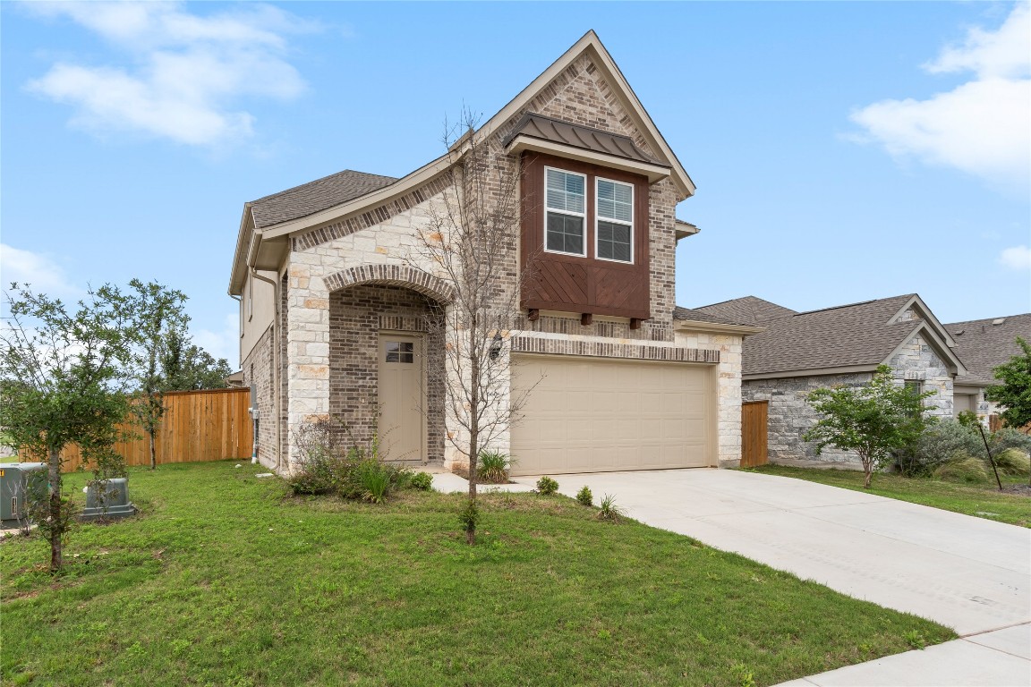 660 Pheasant Hill Lane Georgetown, TX 78628 - Photo 3 of 38 a front view of a house with a garden and plants