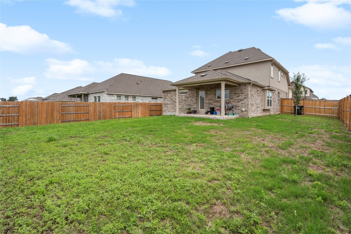 660 Pheasant Hill Lane Georgetown, TX 78628 - Photo 31 of 38 a front view of a house with a yard and garage