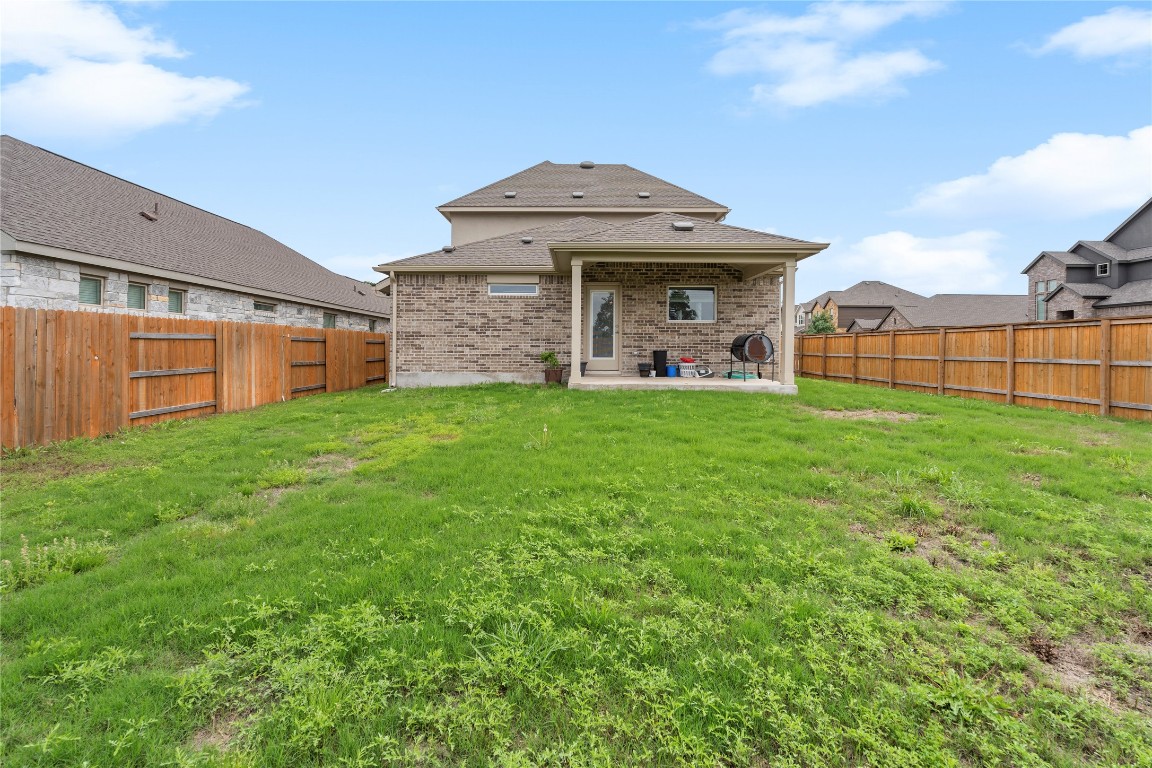 660 Pheasant Hill Lane Georgetown, TX 78628 - Photo 33 of 38 a view of a house with a yard and sitting area