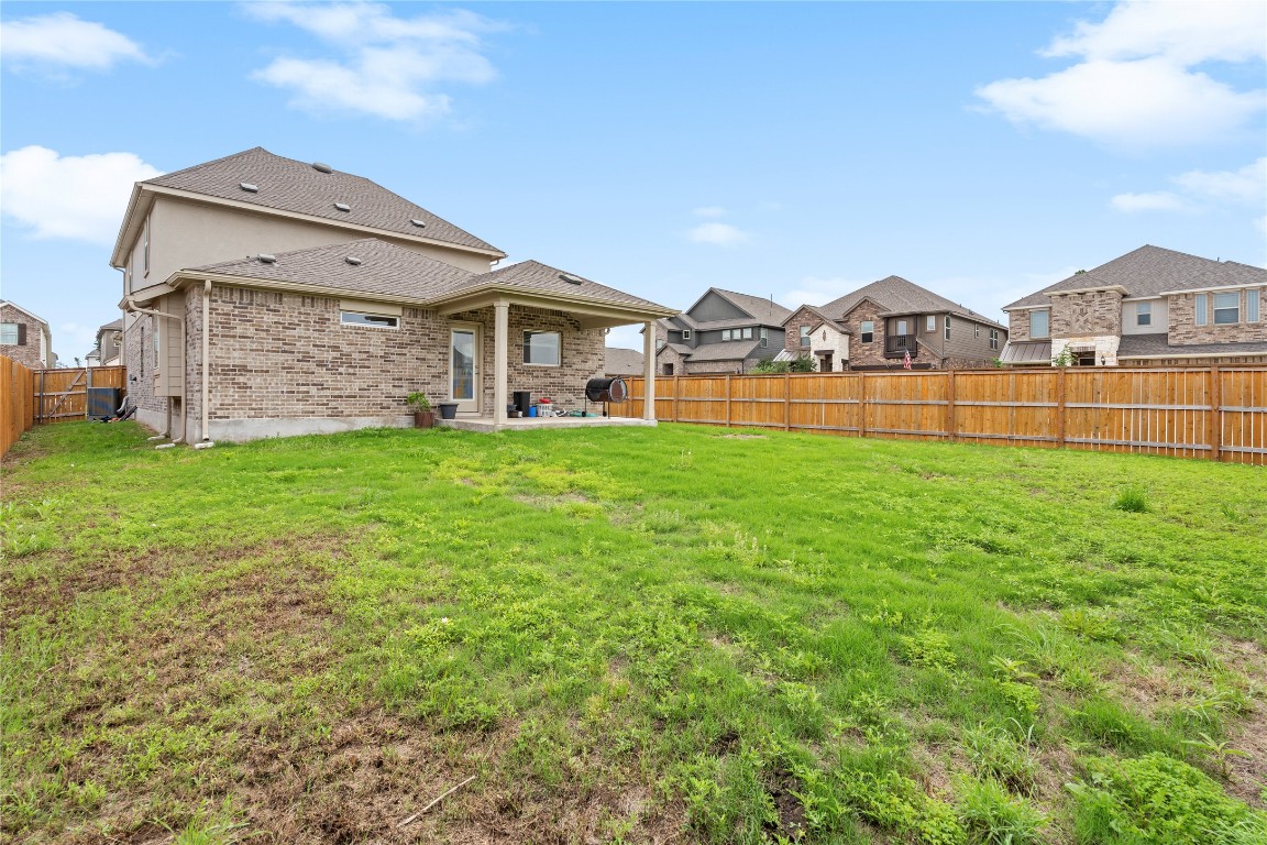 660 Pheasant Hill Lane Georgetown, TX 78628 - Photo 34 of 38 a view of a big house with a big yard and large trees